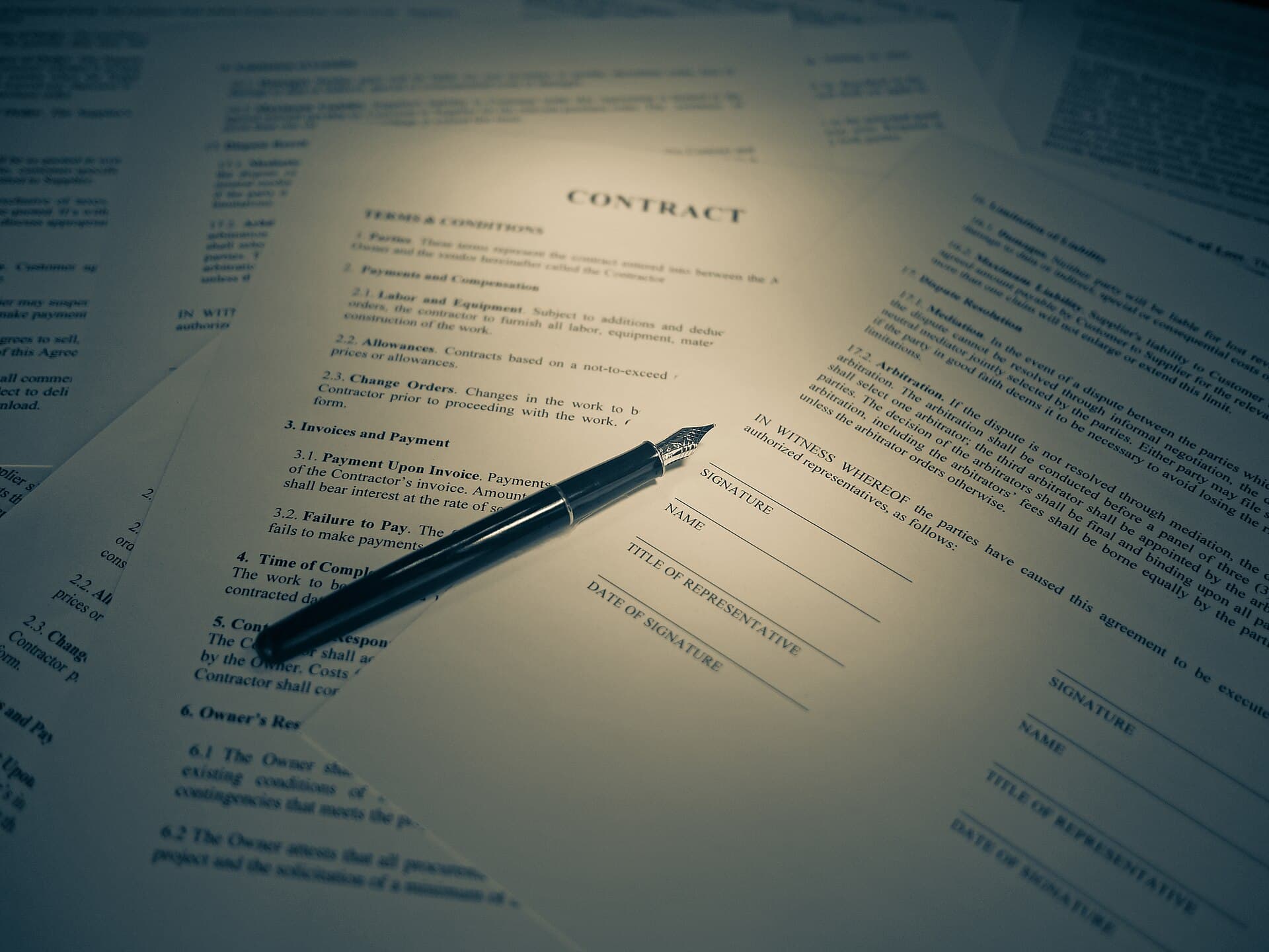 A fountain pen resting on a signed contract